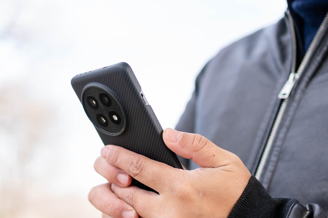 a man holding fiberborne oneplus 13 with aramid fiber case